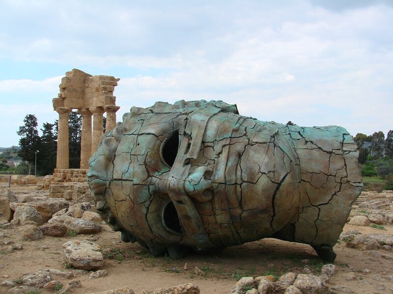 Giant head sculpture at archaeological site