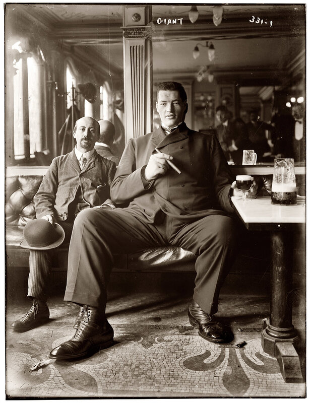 Giant man with cigar in bar
