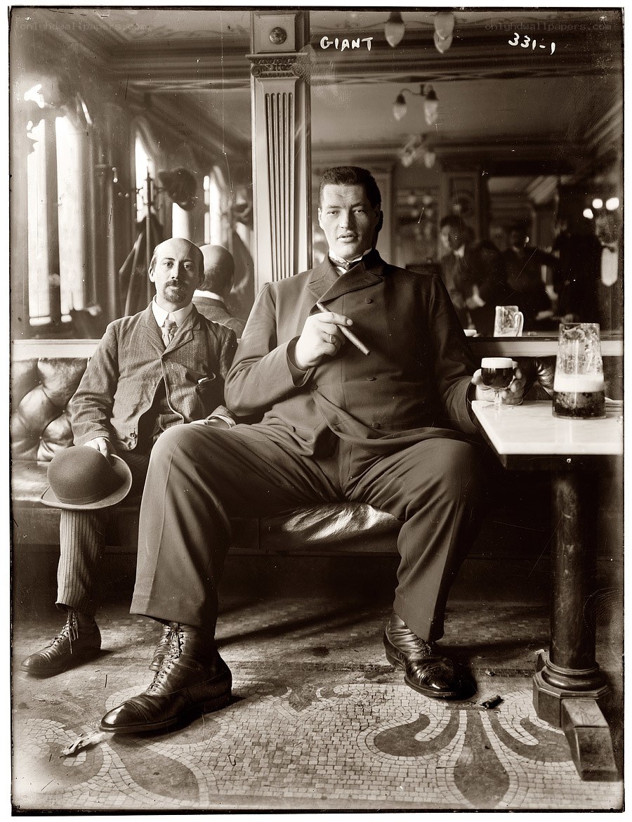 Giant man with cigar in bar