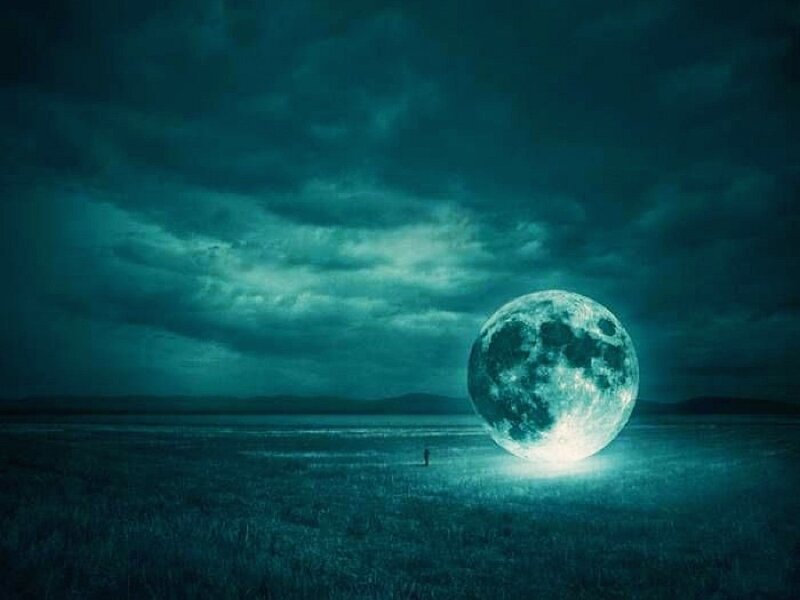 Giant moon over a field