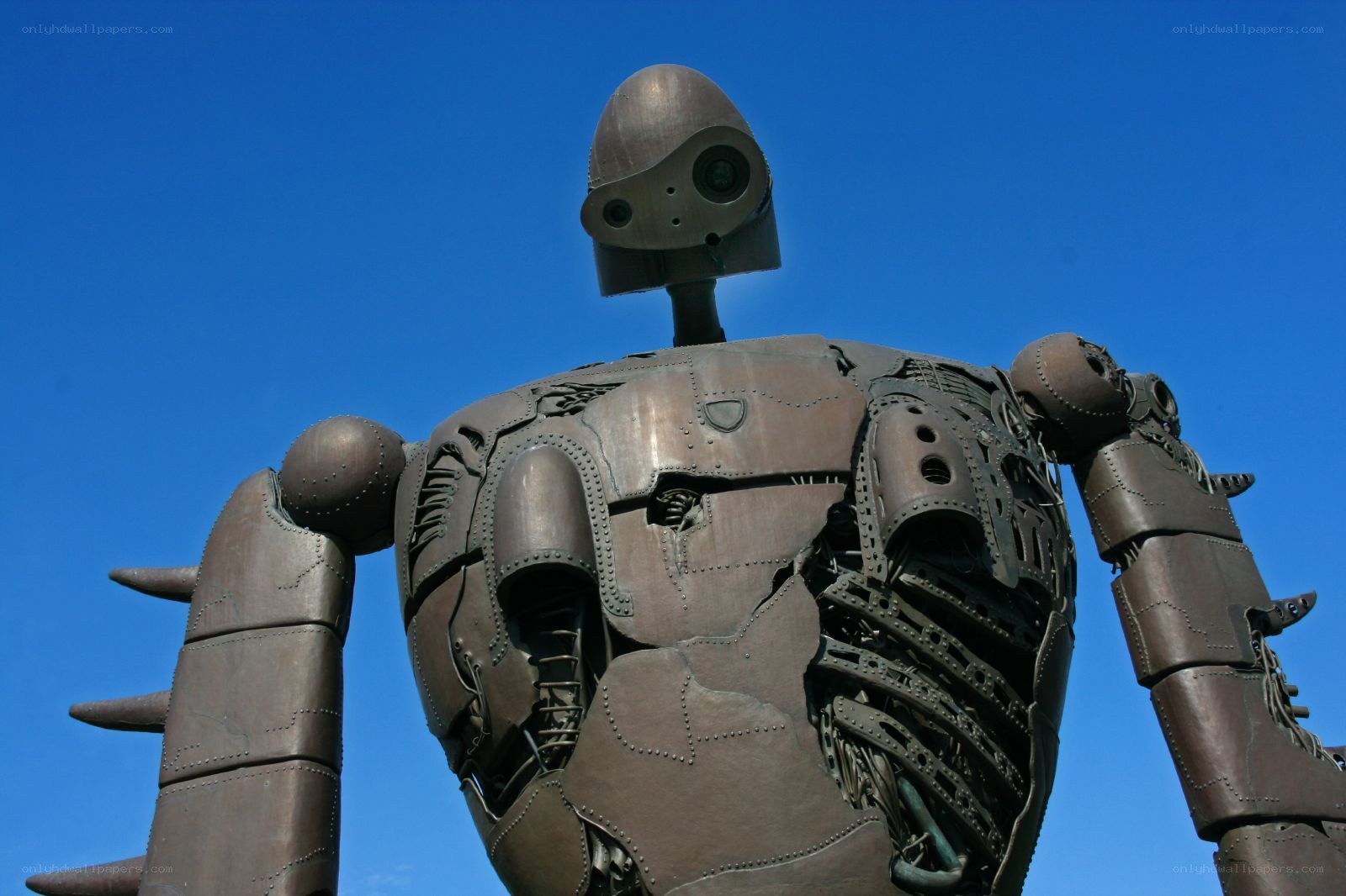 Giant robot statue against blue sky