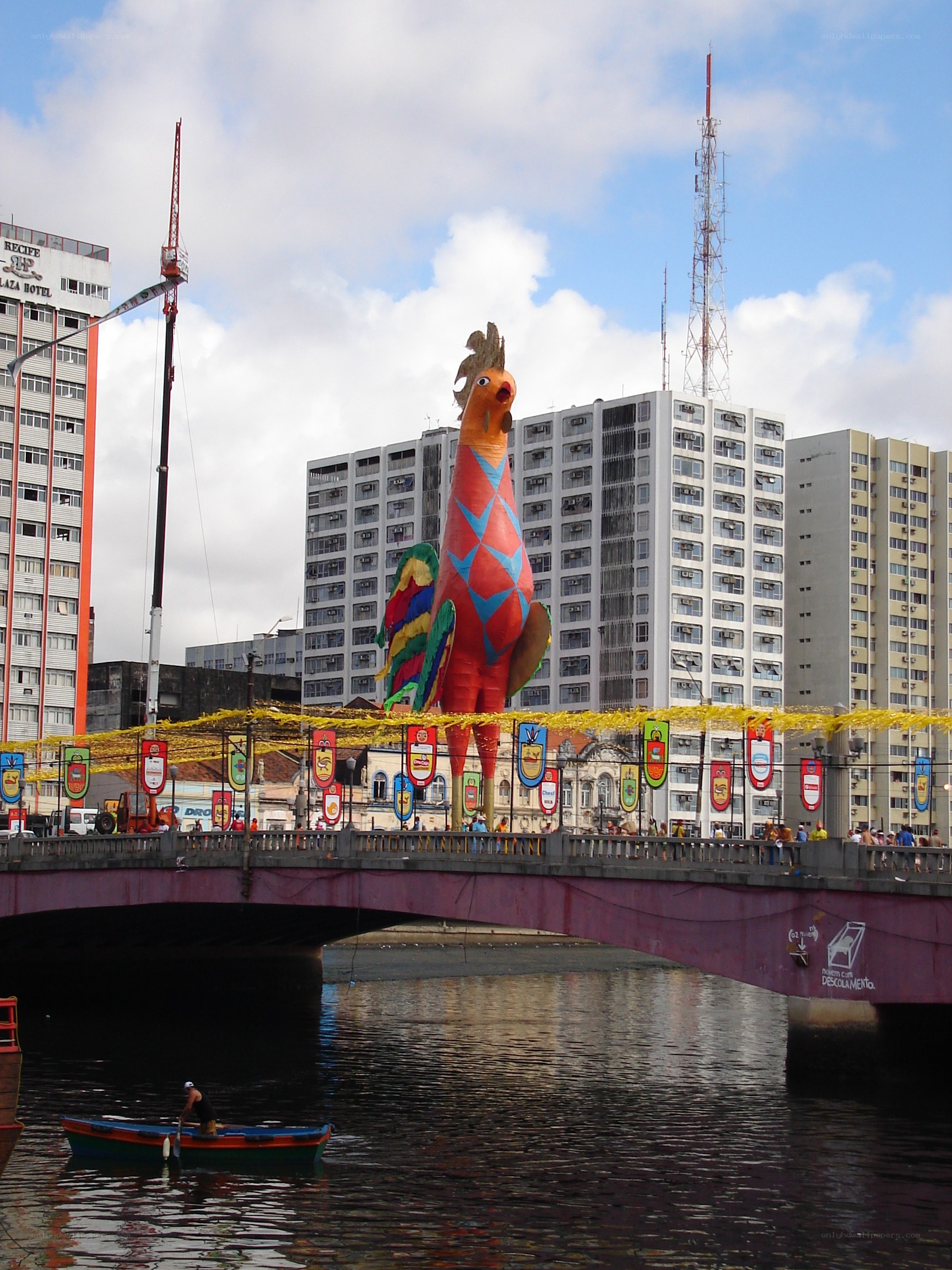 Giant rooster sculpture on bridge