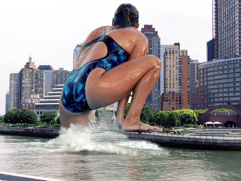 Giant swimmer statue in city