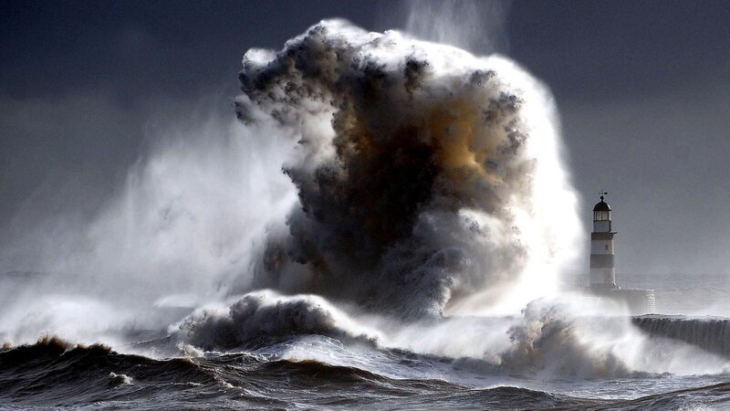 Giant wave crashes at lighthouse