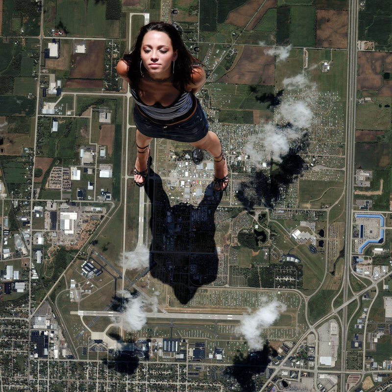 giant woman floating above landscape