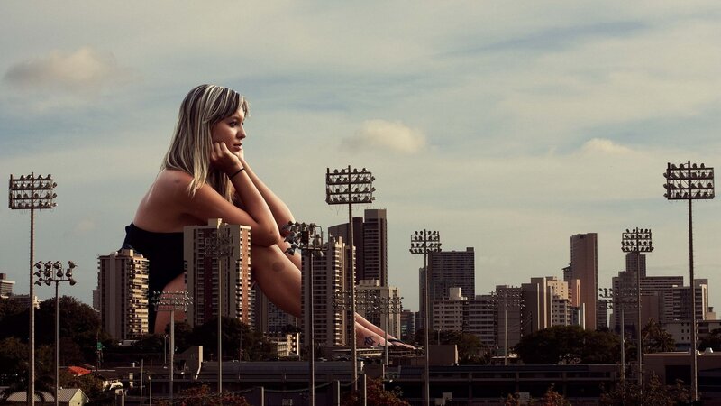 giant woman overlooking city