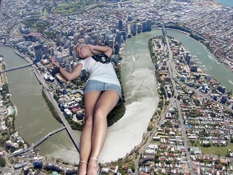 Giant woman sleeping over city