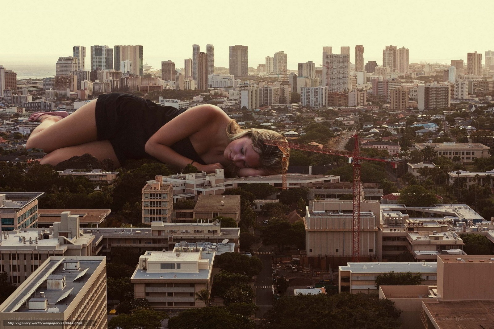 Giant woman sleeping over city