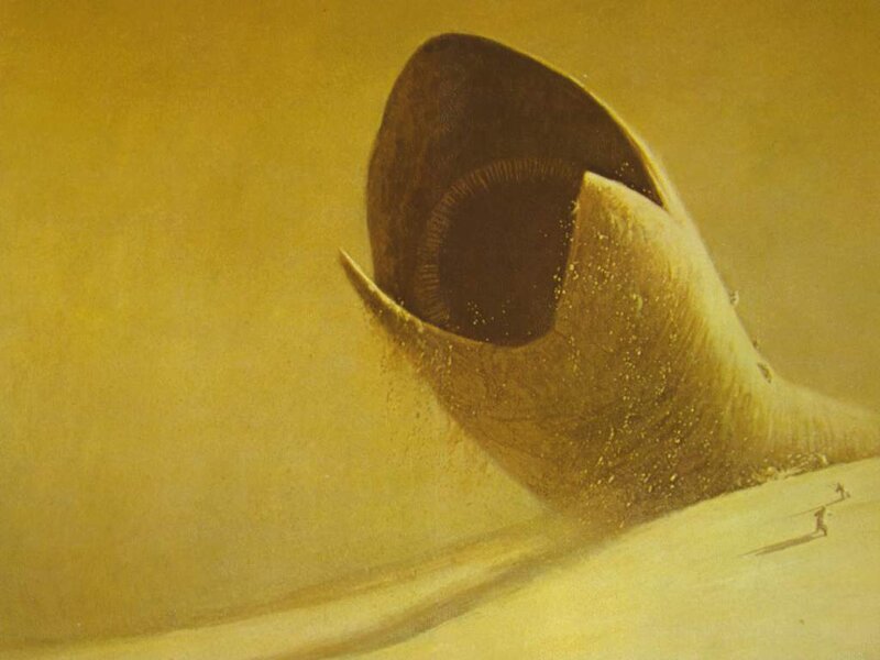 giant worm emerging from sand