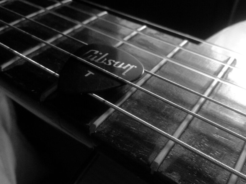 Gibson guitar pick on fretboard