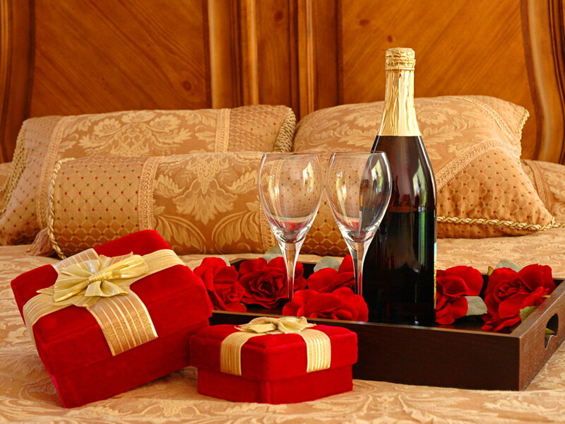 Gifts and Champagne on Bed