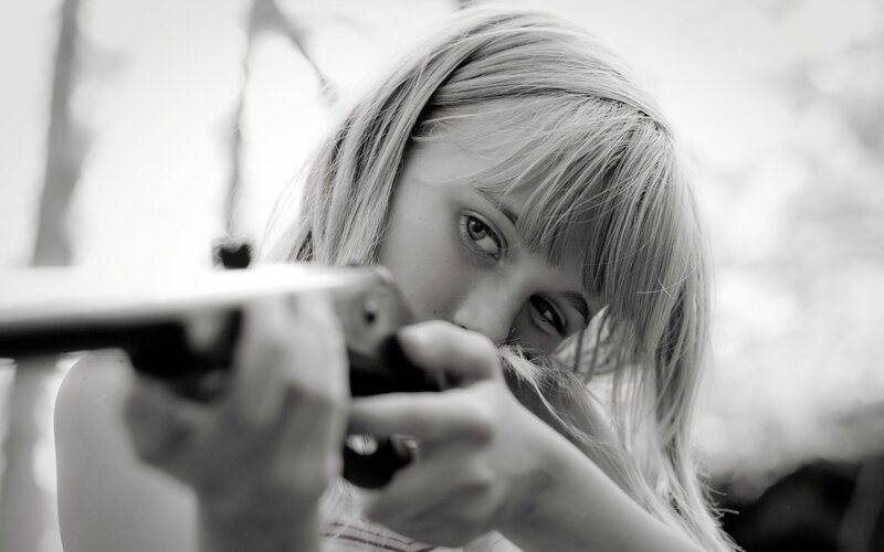 girl aiming a rifle