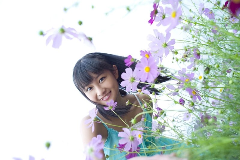 girl among cosmos flowers