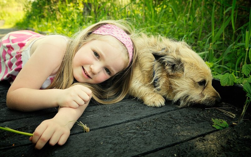 Girl and Dog Lying Down