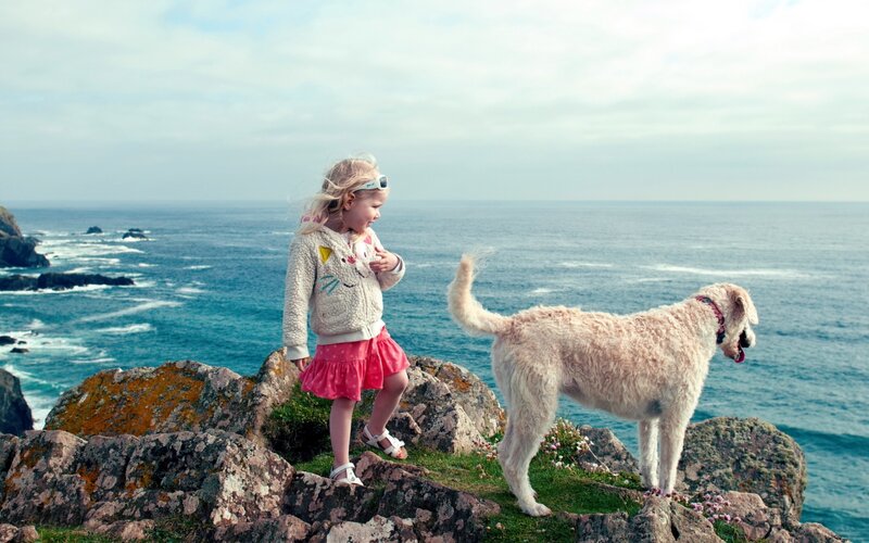 Girl and Dog on Cliff