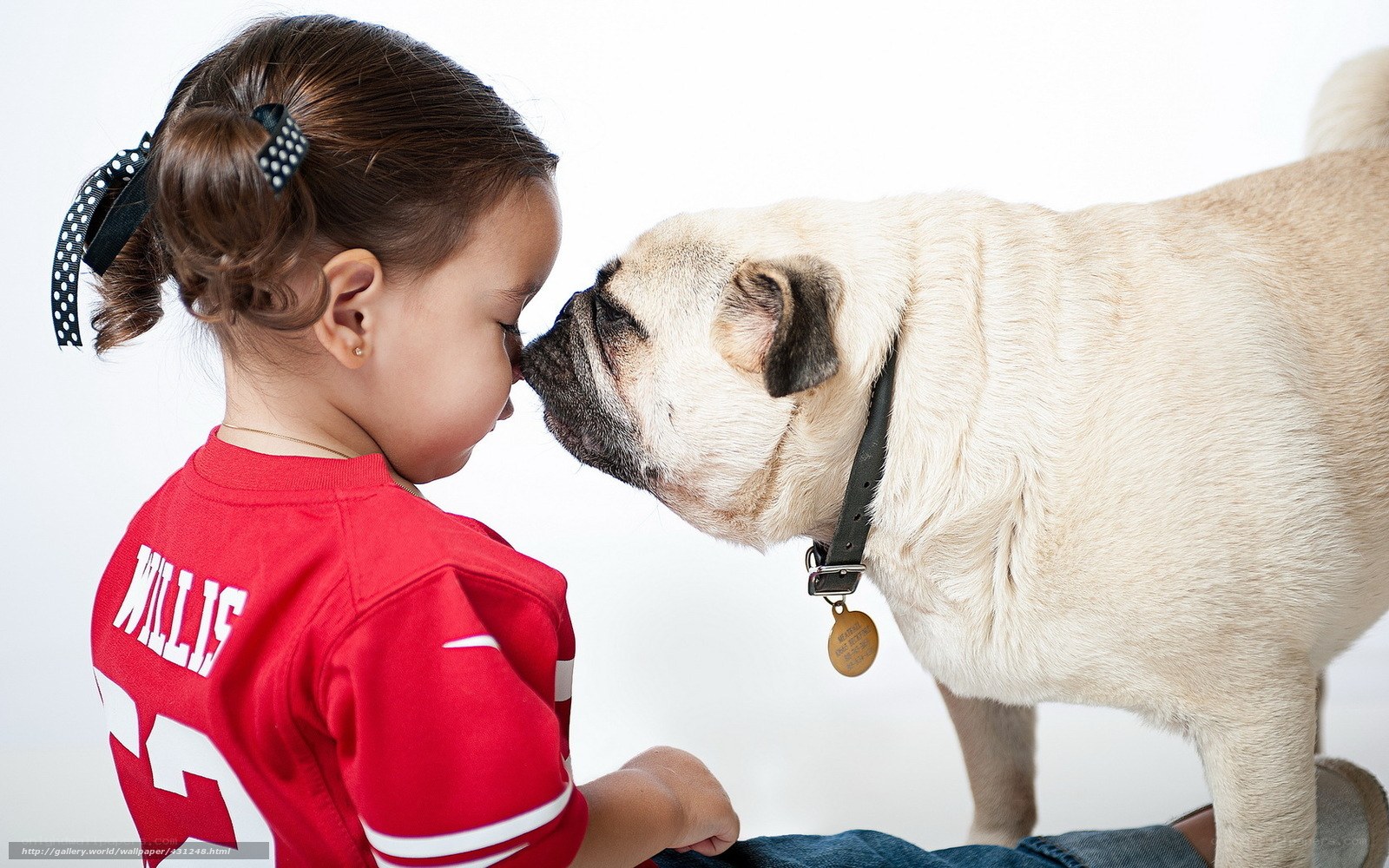 girl and pug touching noses