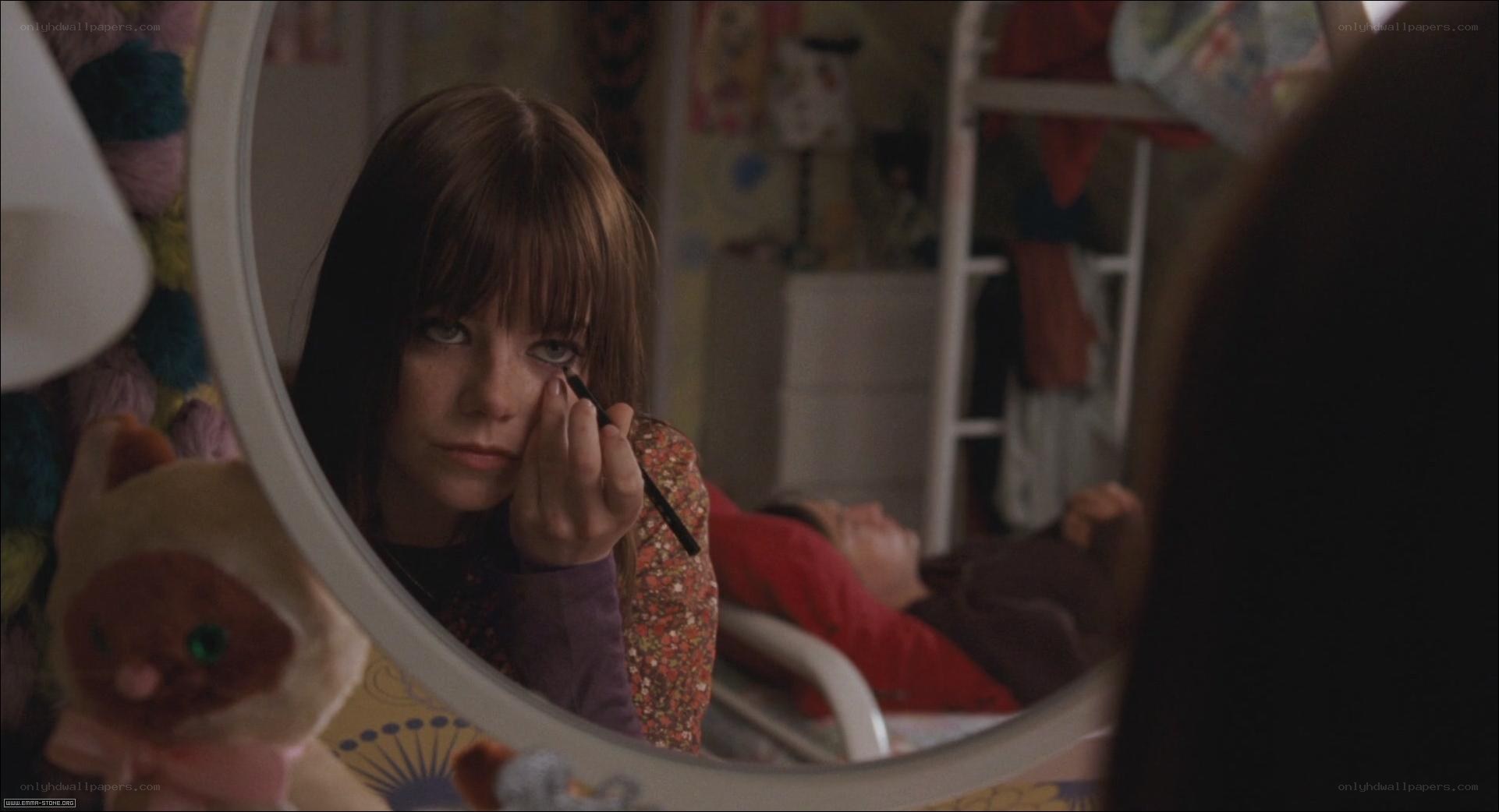 girl applying makeup in mirror
