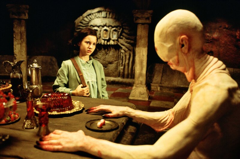 Girl at table with creature