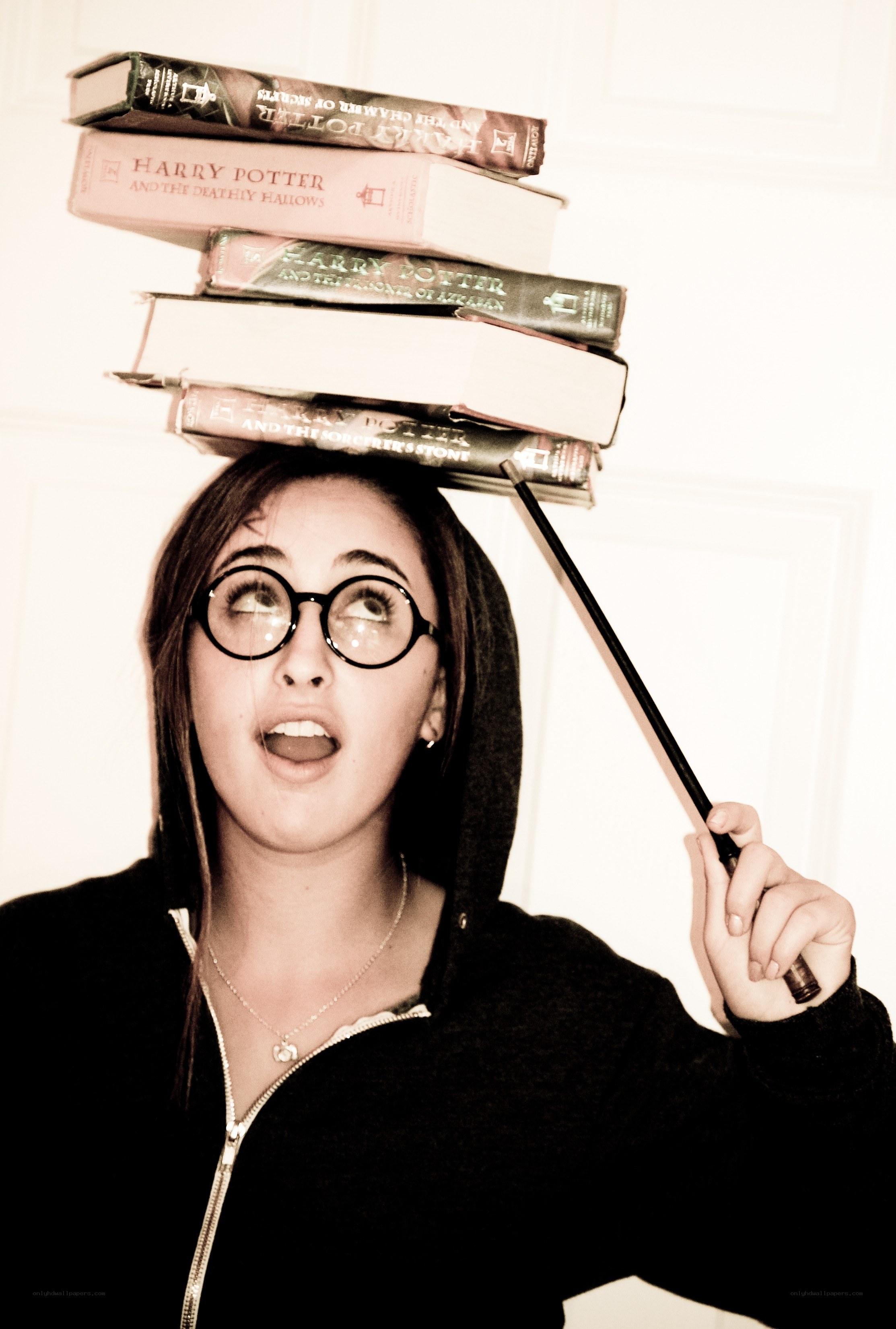 Girl balancing books on head