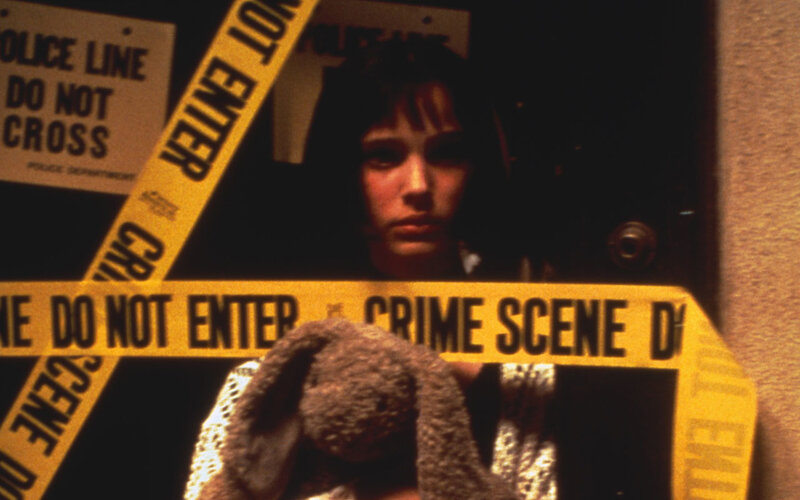 Girl behind crime scene tape