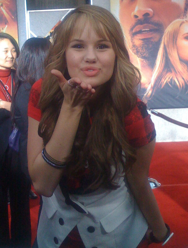girl blowing a kiss at event