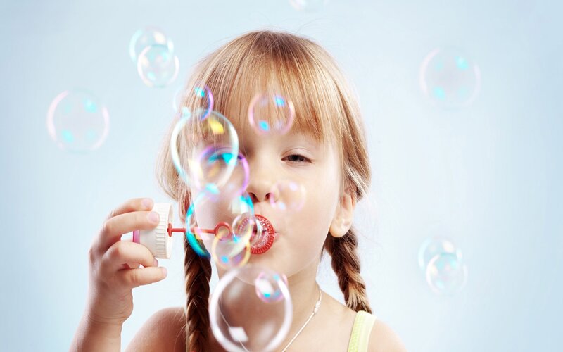 Girl Blowing Bubbles — Blue, Playful
