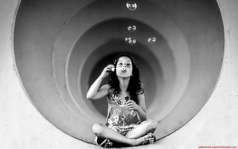 girl blowing bubbles in tunnel