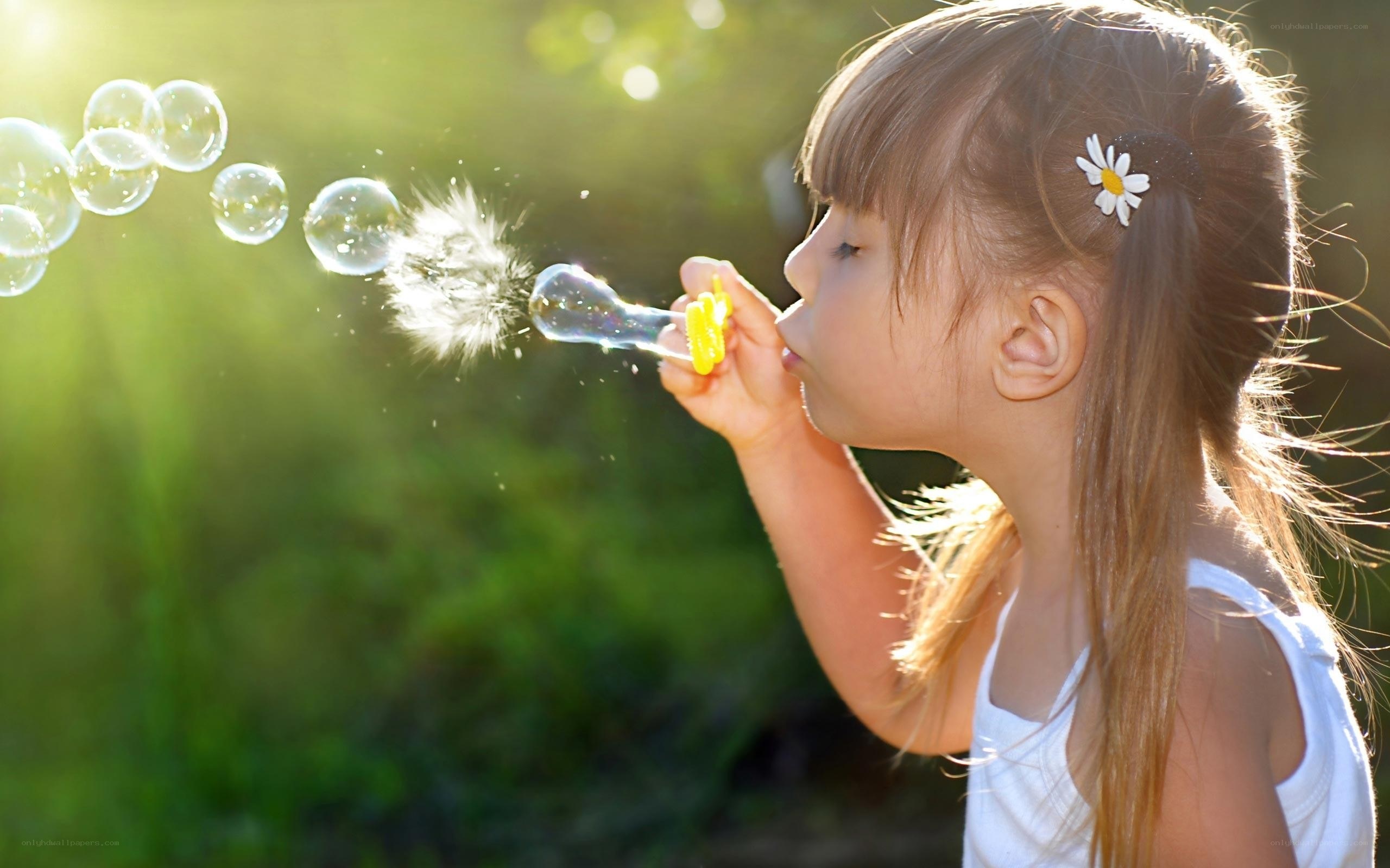girl blowing bubbles outdoors