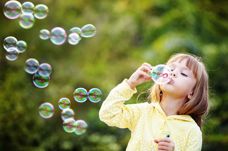 Girl Blowing Bubbles — Yellow, Playful