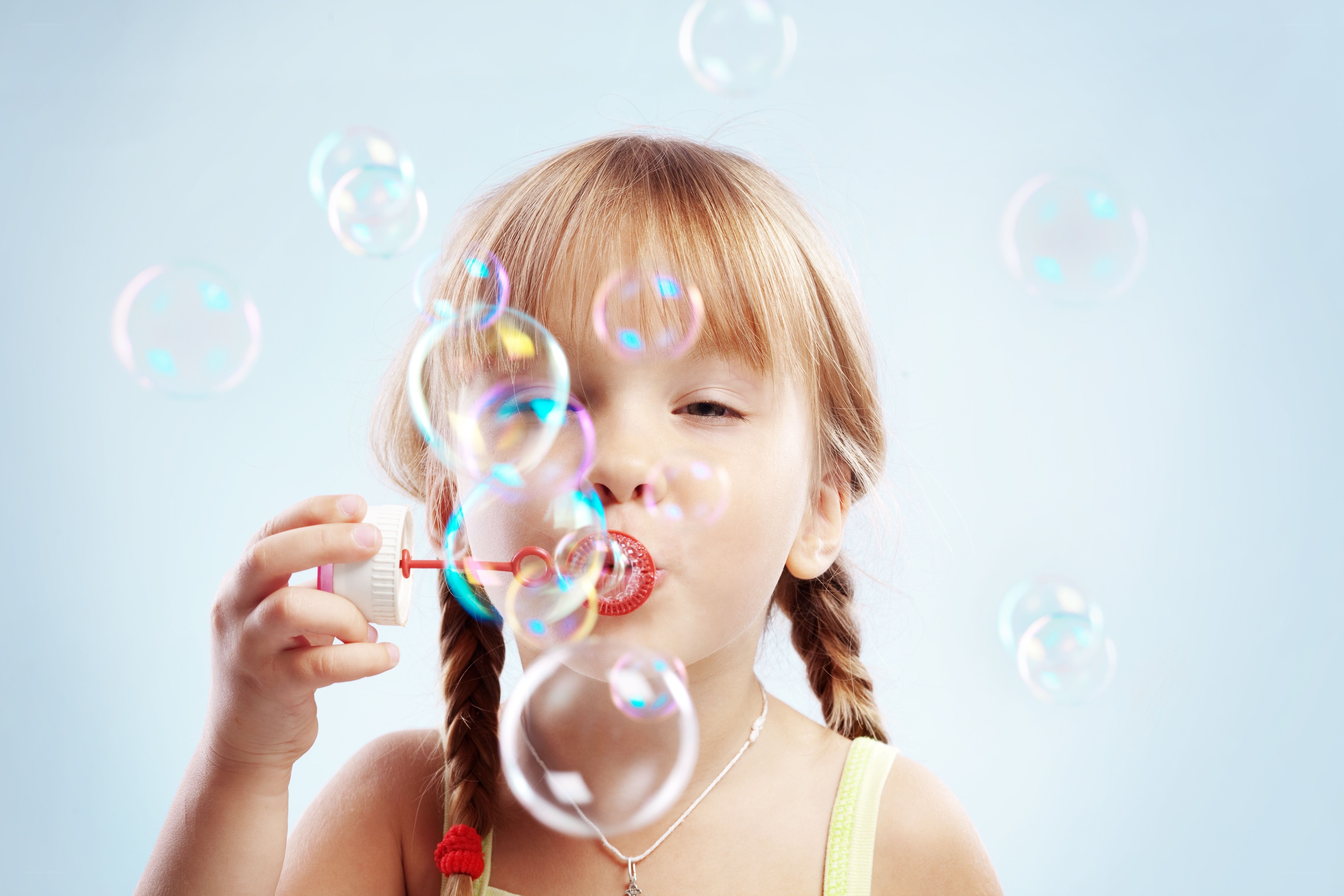 girl blowing bubbles
