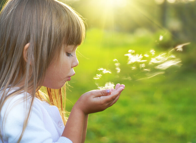 Girl Blowing Dandelion Seeds — Green