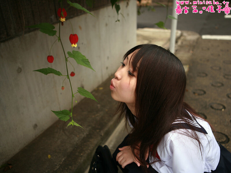girl blowing on a flower