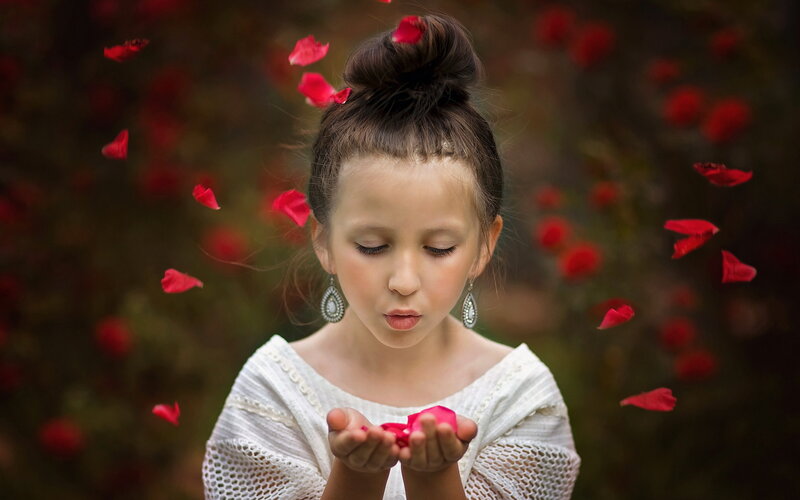 Girl Blowing Rose Petals