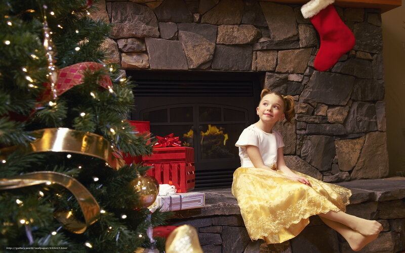 Girl by the fireplace at Christmas
