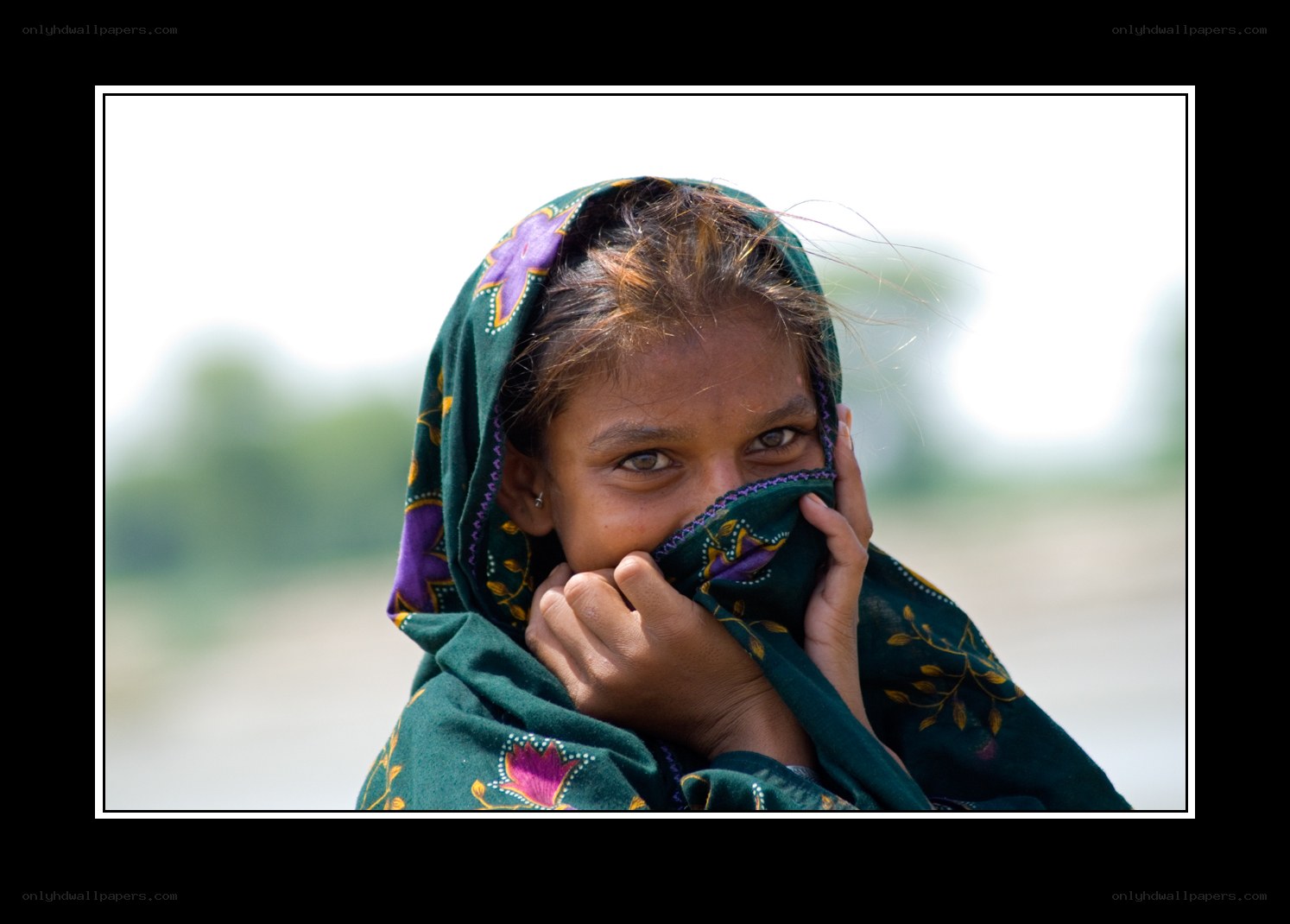 girl covering face with scarf