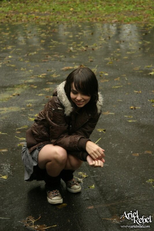 girl crouching in puddle