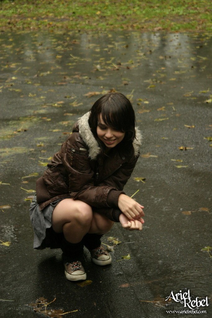 girl crouching in puddle