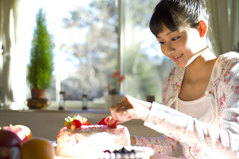 girl decorating a cake