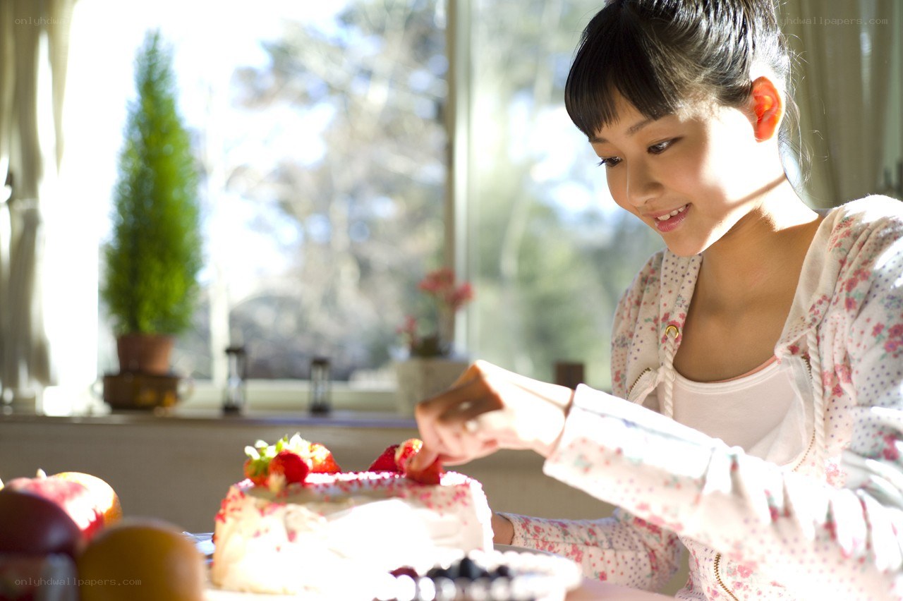 girl decorating a cake