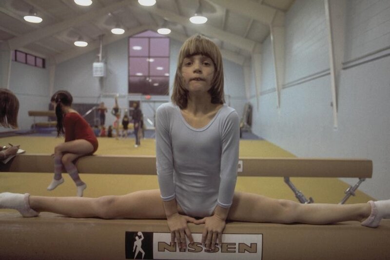 Girl Doing Split on Beam