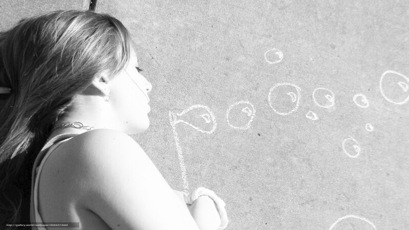 Girl drawing bubbles on pavement