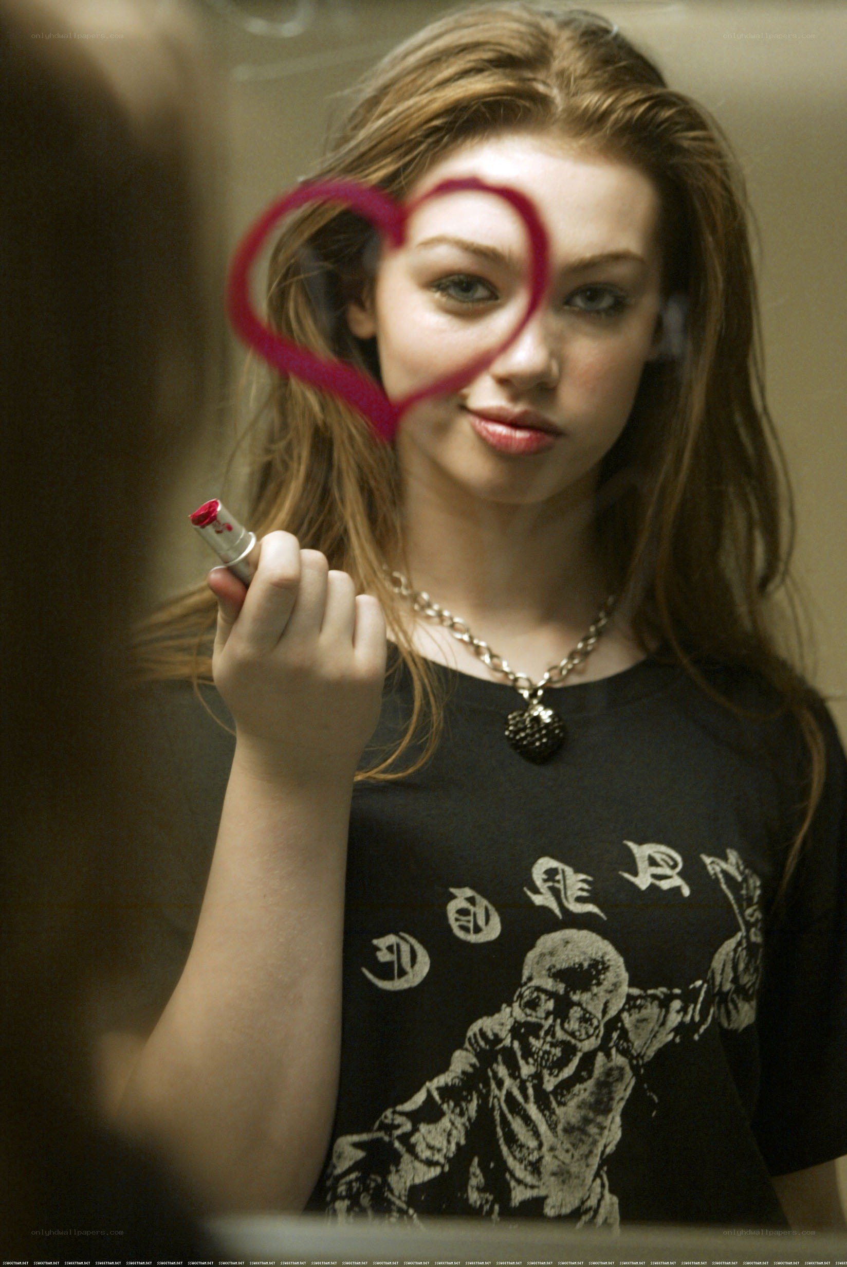 girl drawing heart on mirror