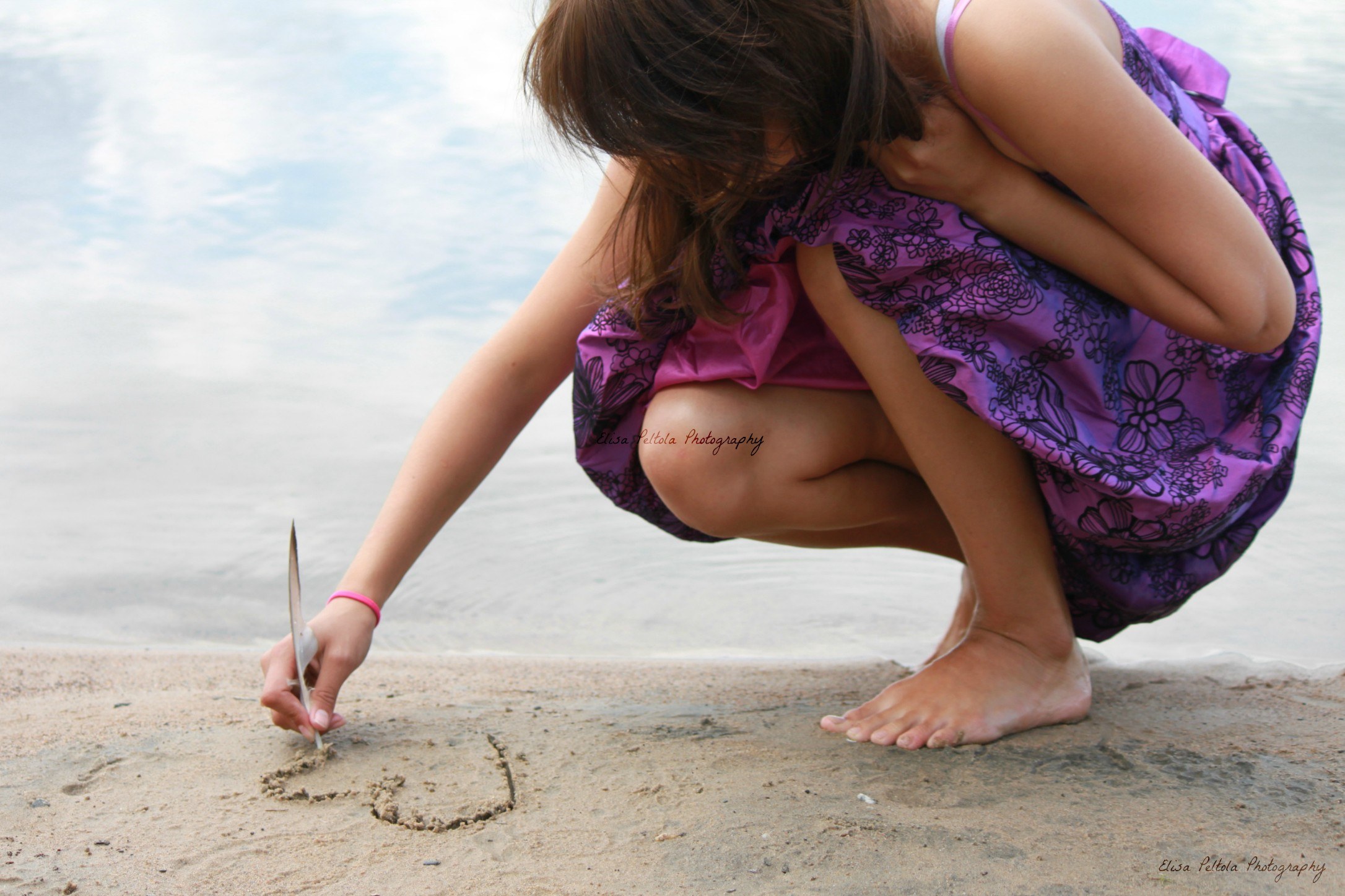 girl drawing in the sand
