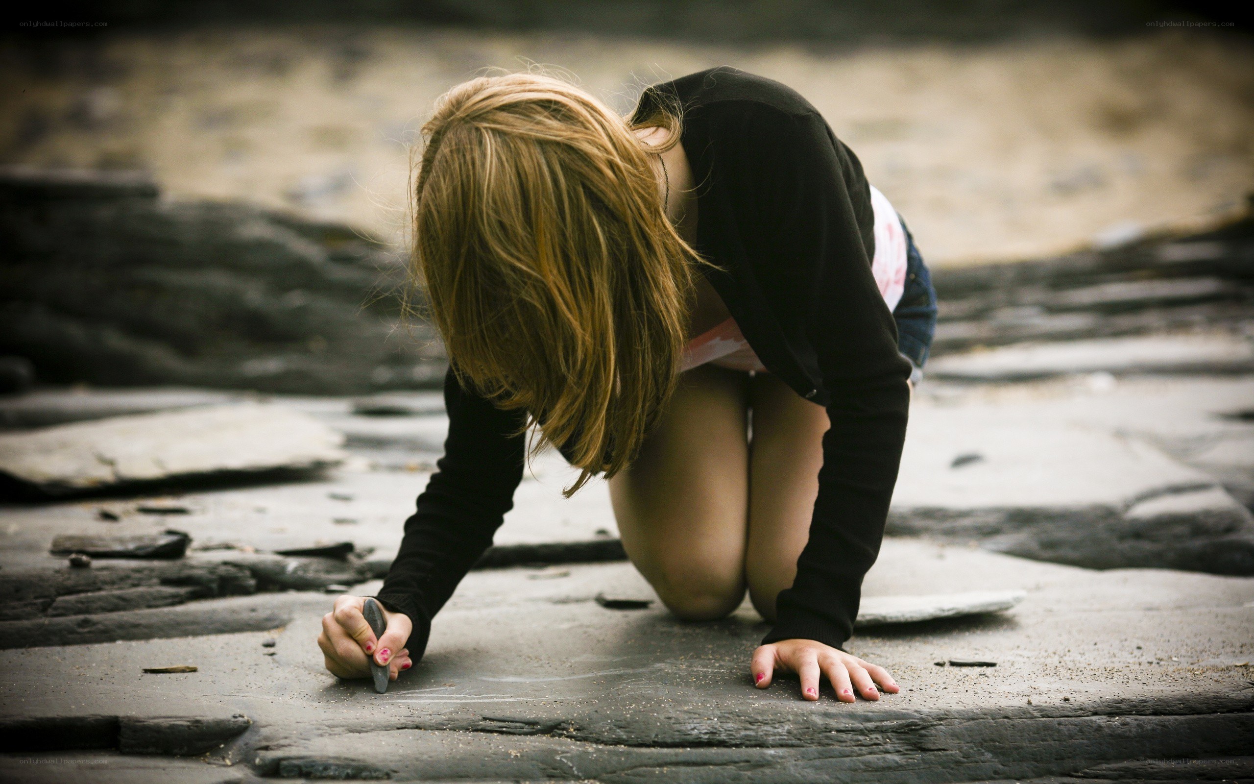 Girl drawing on stone