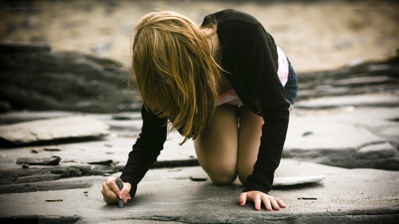 Girl drawing on stone