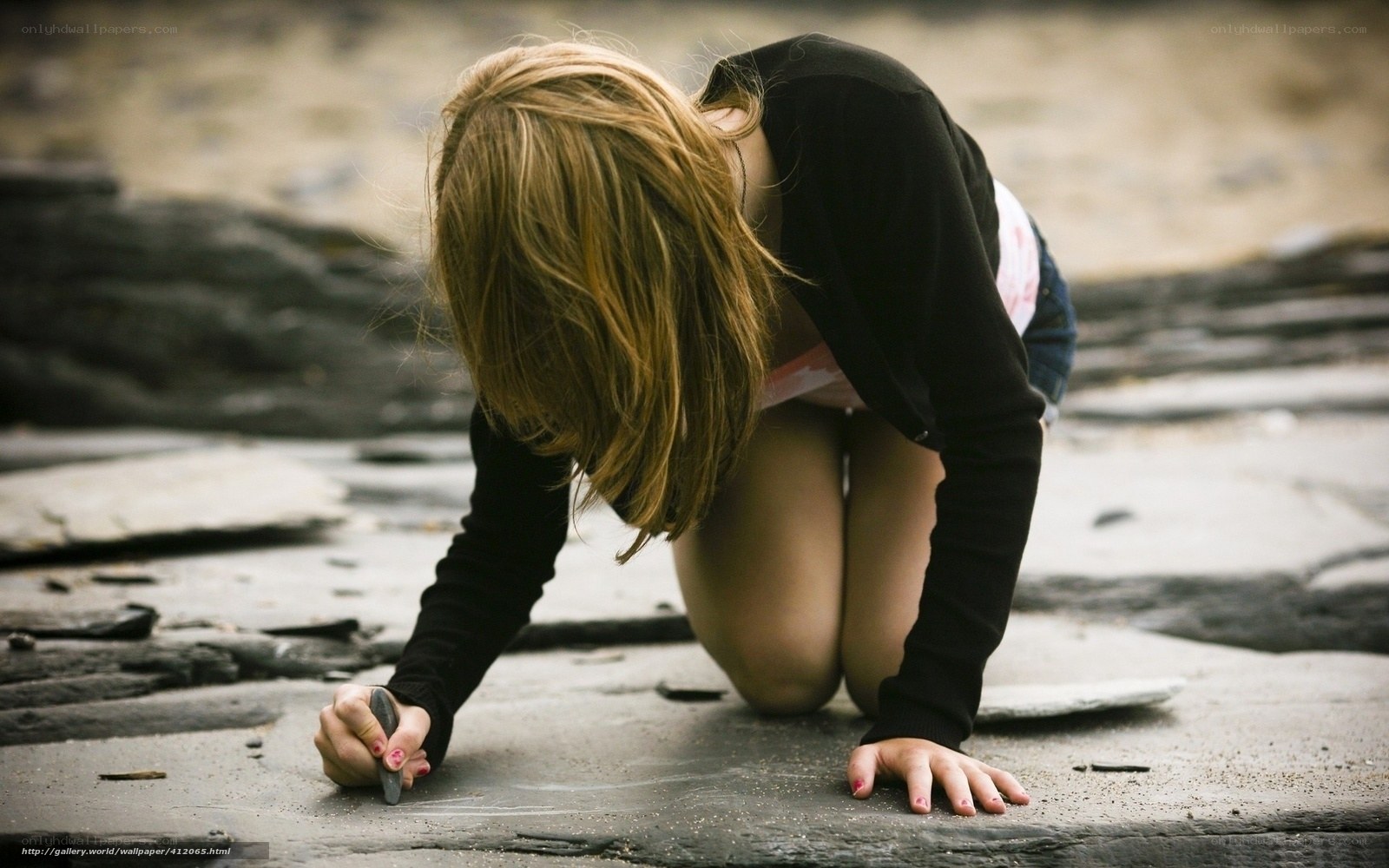 Girl drawing on stone