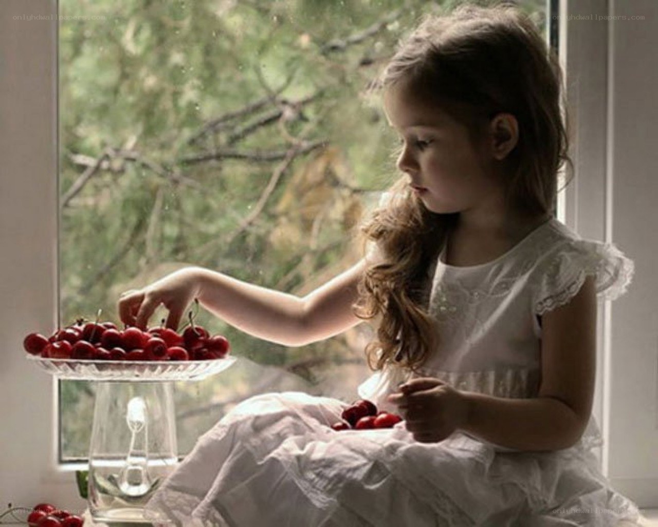 girl eating cherries by window