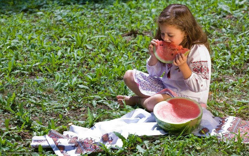 Girl eating watermelon outdoors