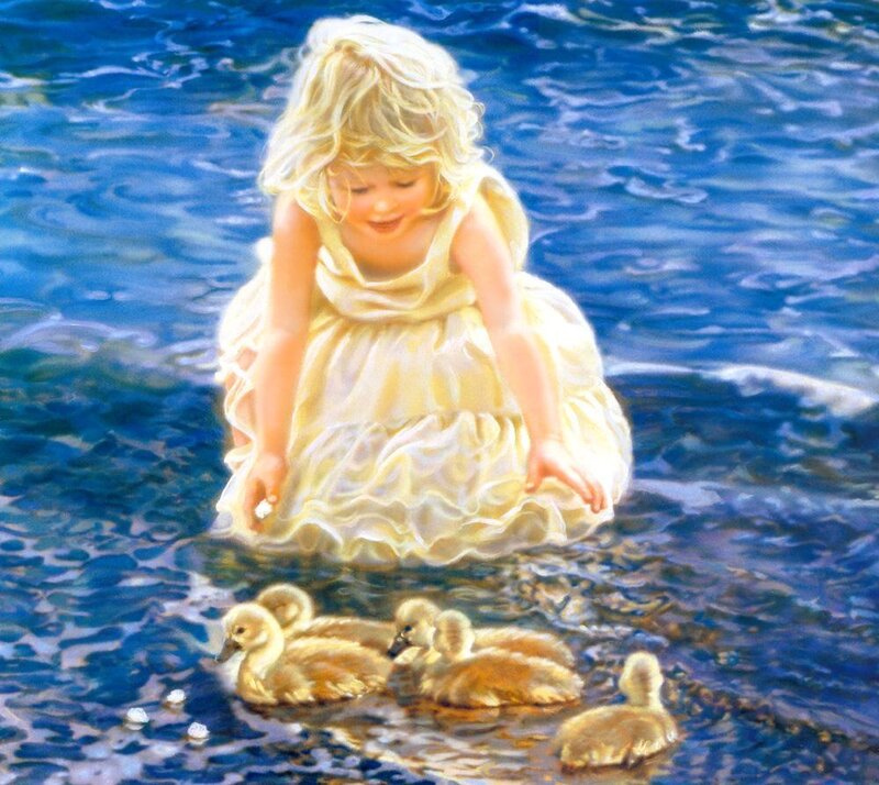 Girl feeding ducklings in water