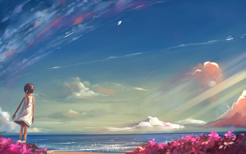 Girl flying a kite by the sea